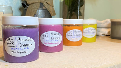 Five jars in a line displaying sugar scrub varieties